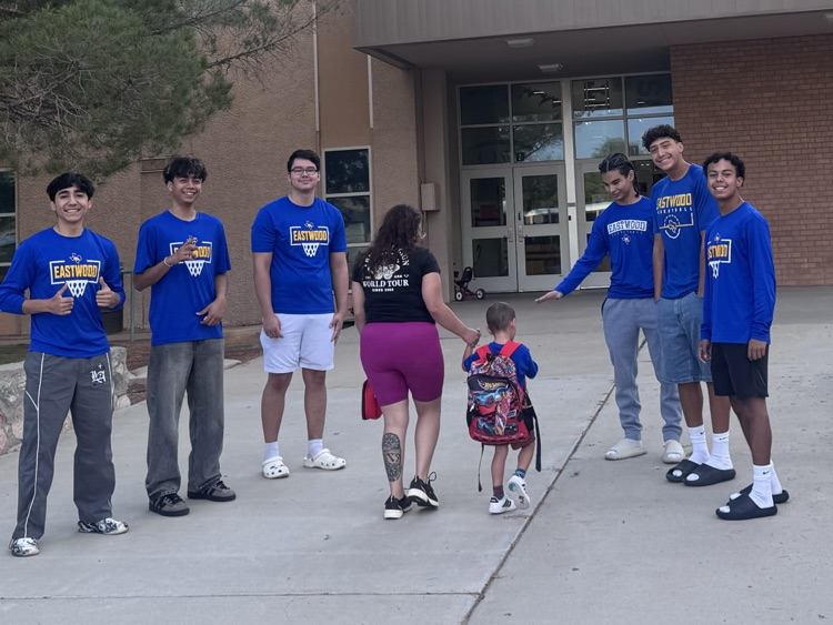 boys from basketball team welcoming in student 