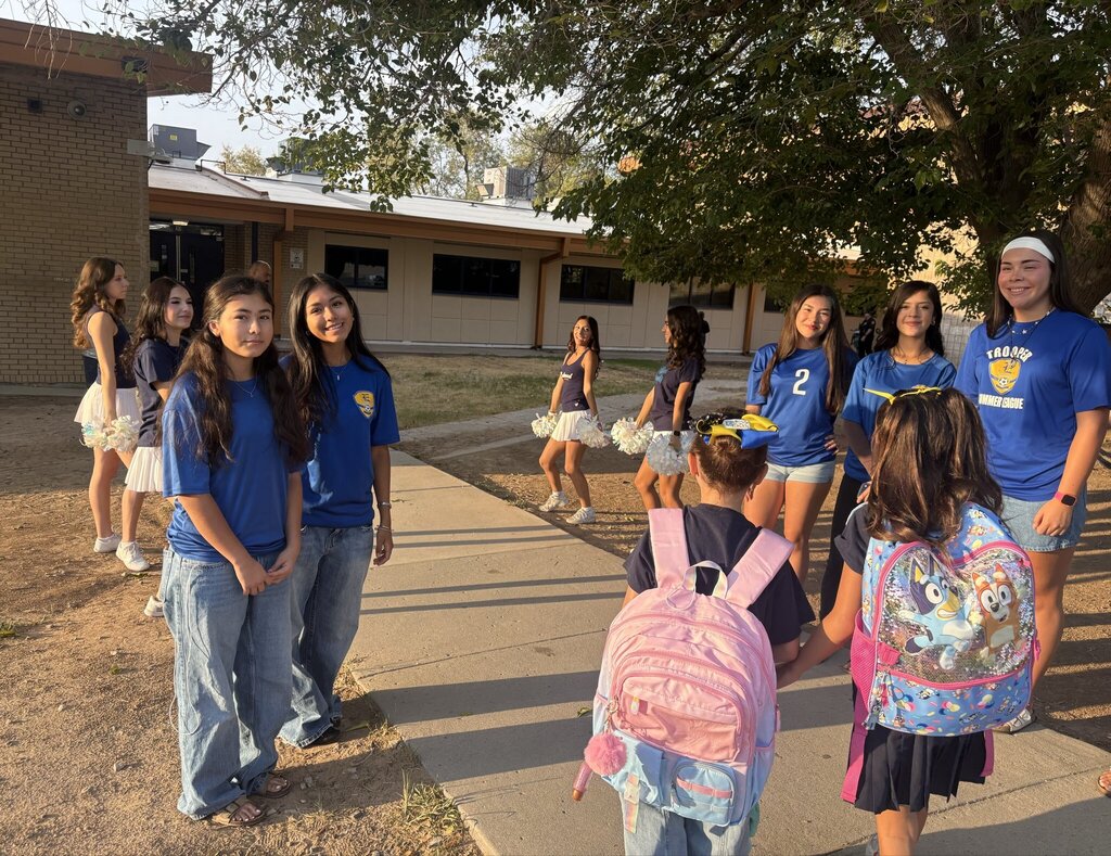 Photo of Eastwood High School soccer players and Cheerleaders welcoming in Eastwood Knolls students at the main entrance early on Friday morning.