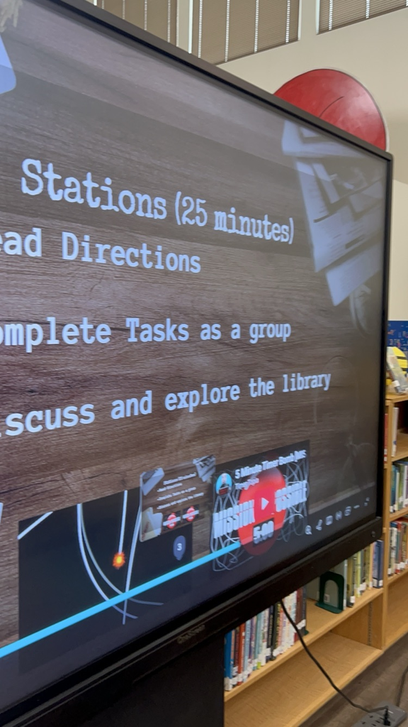 screen with instructions on stations  for library instruction 