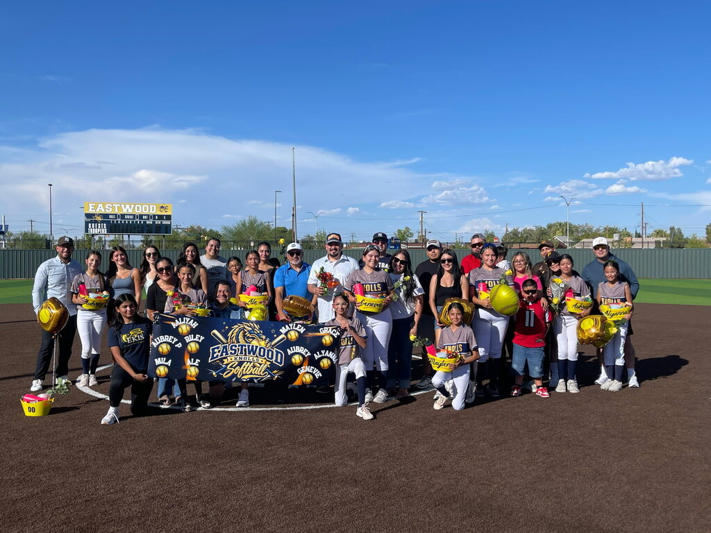 Group photo of the EKIS 8th-grade softball team with their parents.
