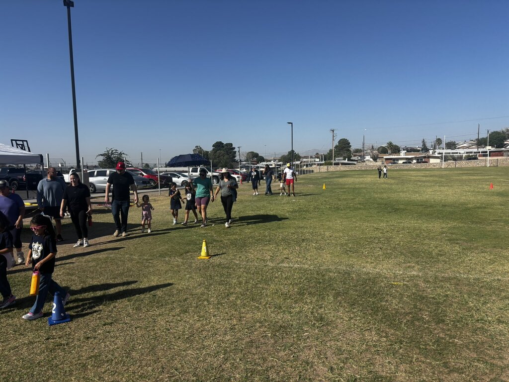 Photo of EKIS students participating a a Wellness Walk with their family members.