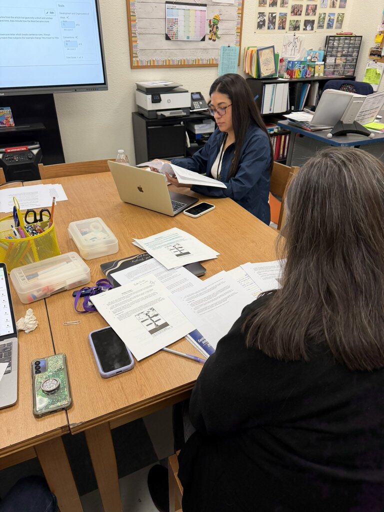 Photo of EKIS ELAR teachers meeting during PLT to review and analyze student responses to identify needs and plan for supporting each student.