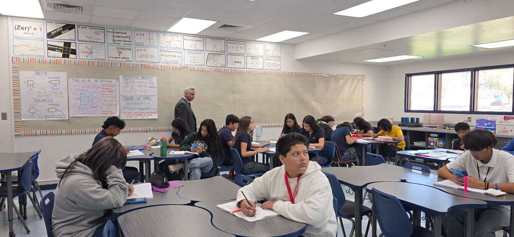 Photo of Dr. De La Torre visiting a classroom at EKIS.