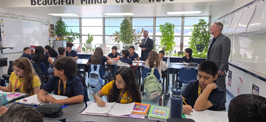 Photo of Dr. De La Torre visiting a classroom at EKIS.