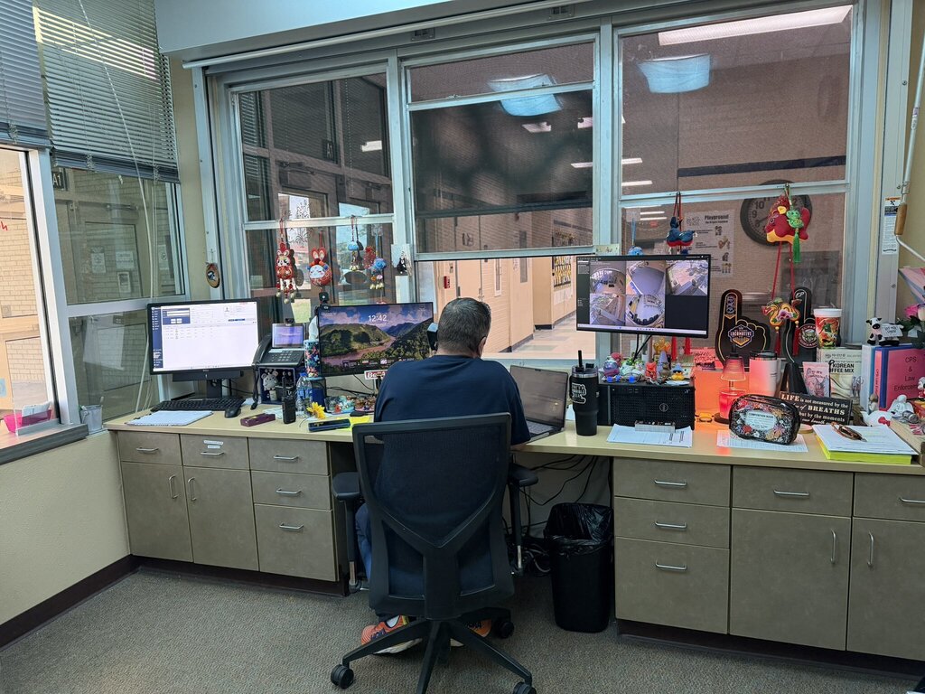 Photo of Mr. Puga helping out by covering the front desk at EKIS.