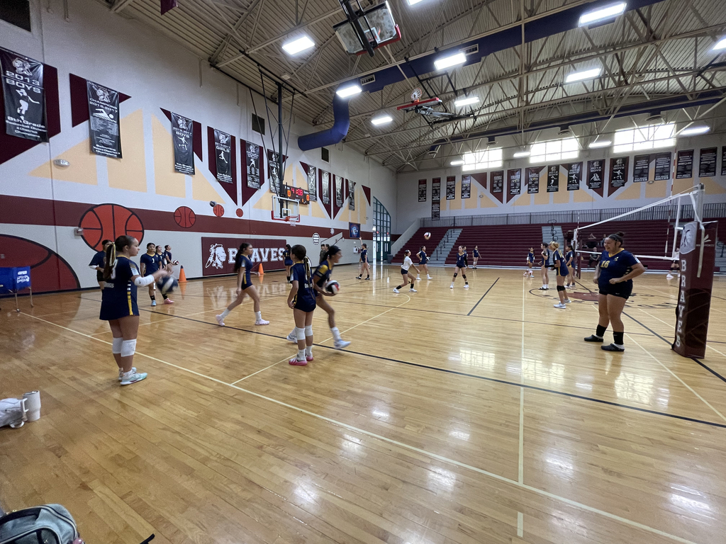Photo of EKIS 7th- and 8th-grade volleyball players warming up before a game against YMS.