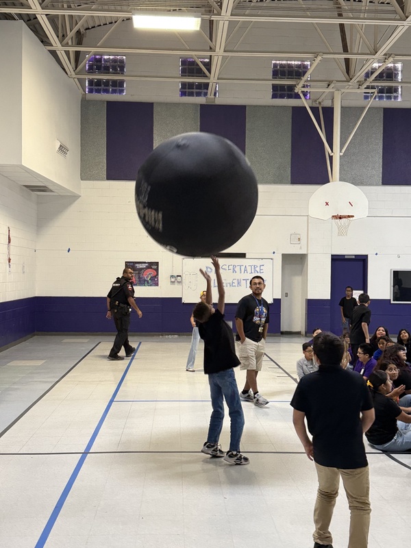 Students reaching up for the  ball. 