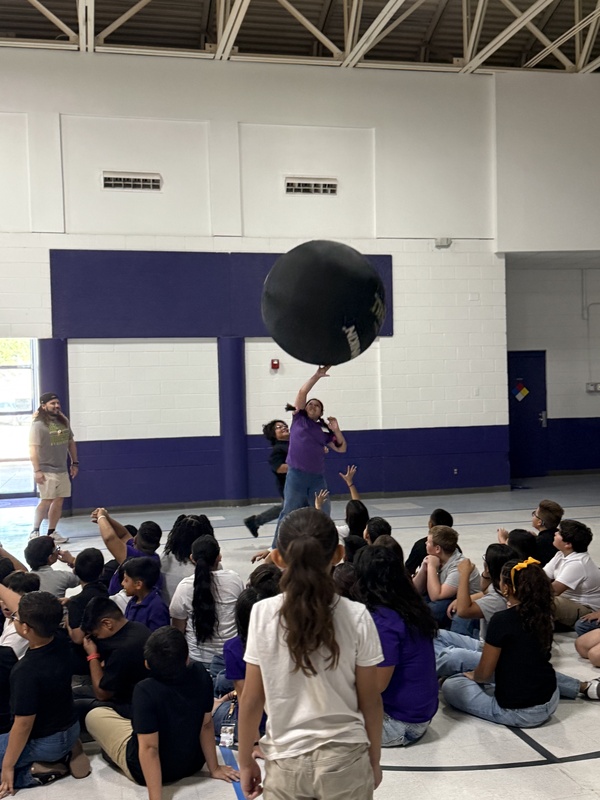Students reaching up for the  ball. 