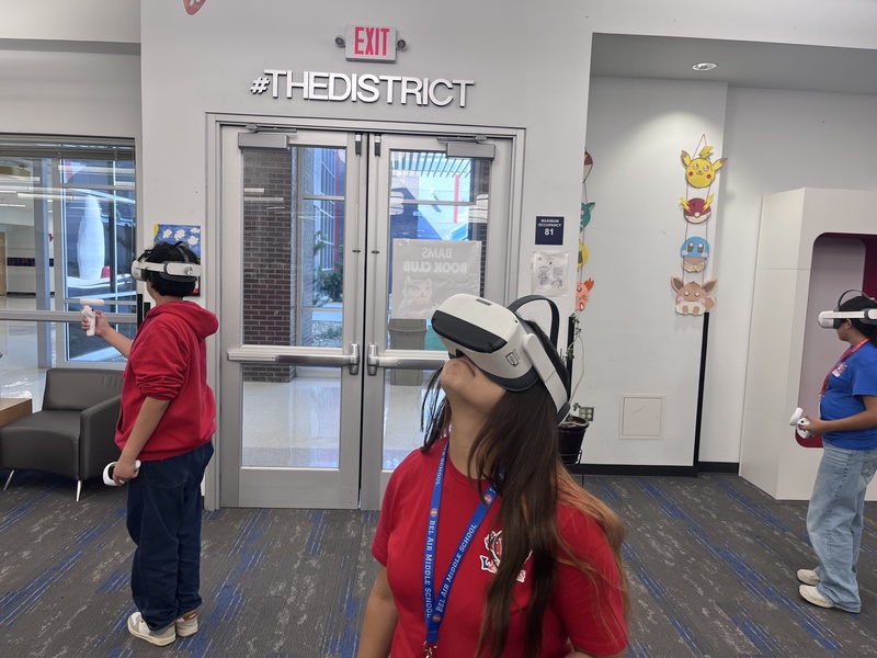 Multiple Bel Air Middle School student in the library learning Math while wearing Virtual Reality Headsets