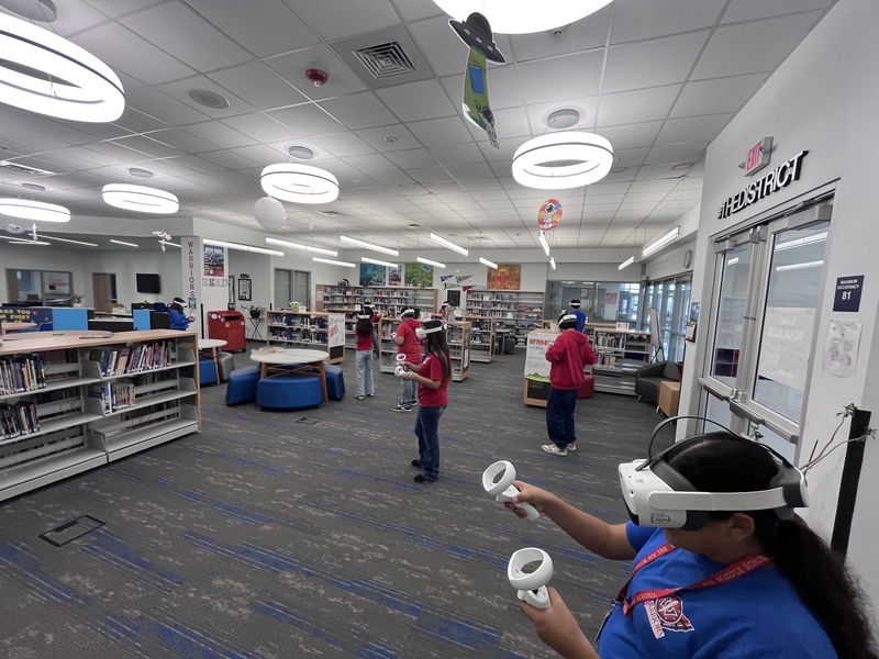 Students in the Bel Air Middle School Library wearing Virtual Reality Headsets learning about Math