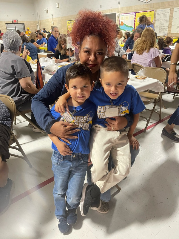 grandma hugging 2 grandkids 