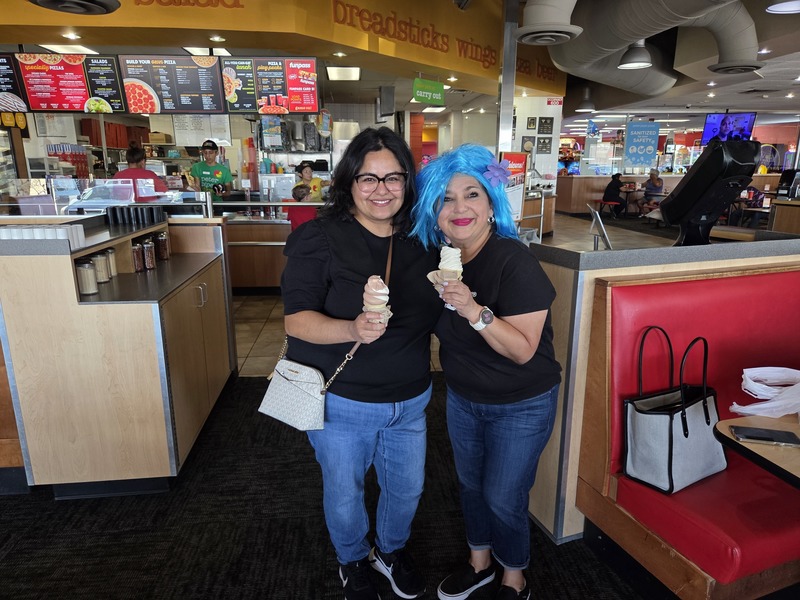 Two employees of Presa pose with their ice cream