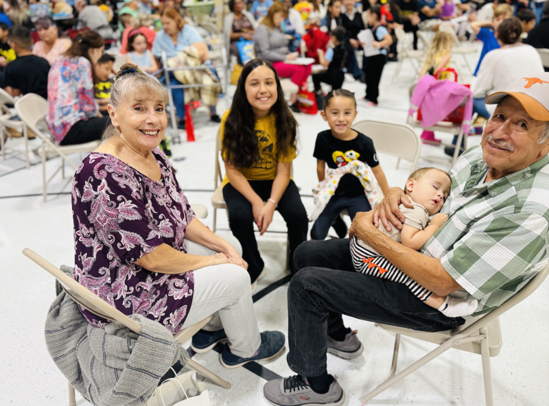 grandparents reading with their grandchild