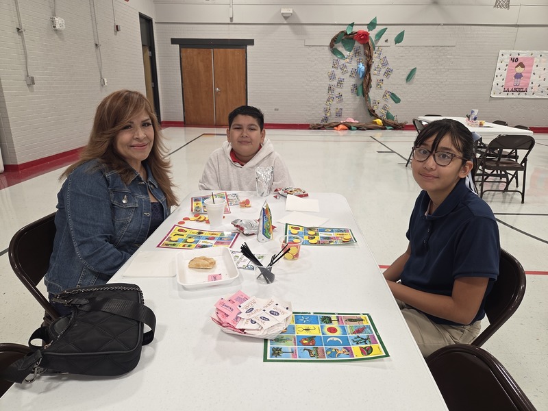 Grandma, grandson and granddaughter playing Loteria
