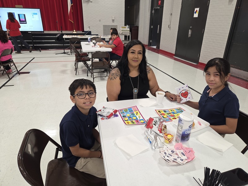 Grandma, grandson and granddaughter playing Loteria