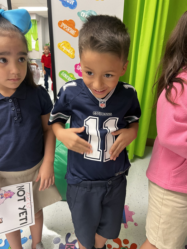 PreKinder student show off his Dallas Jersey