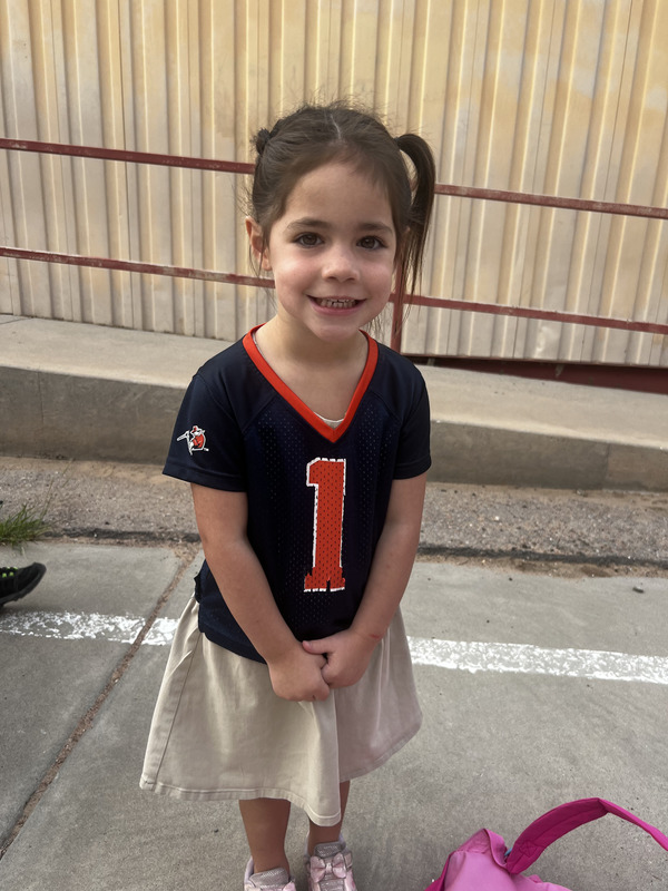 Pre-Kinder Student poses with her jersey