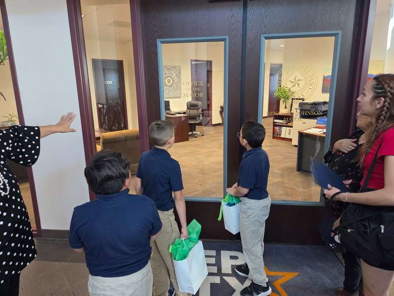 Student looking through doors  to City Office