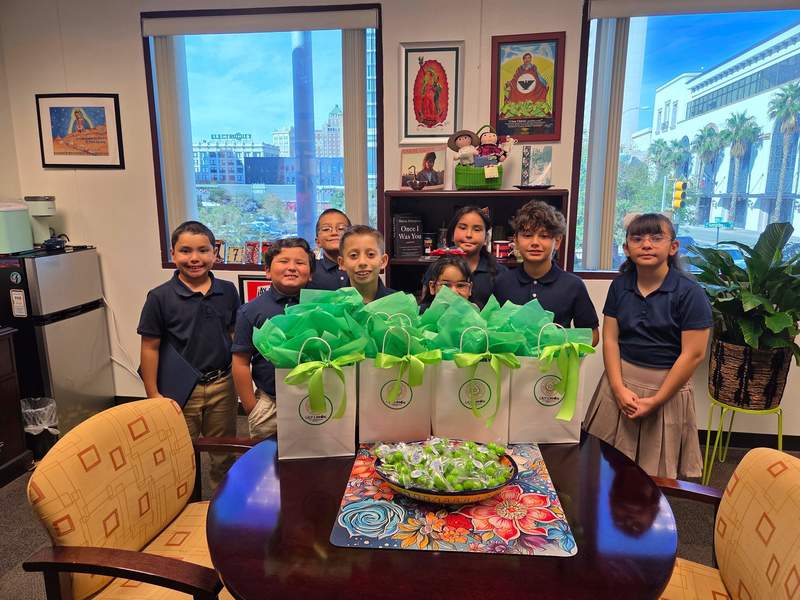Students stand behind their goodie bags 