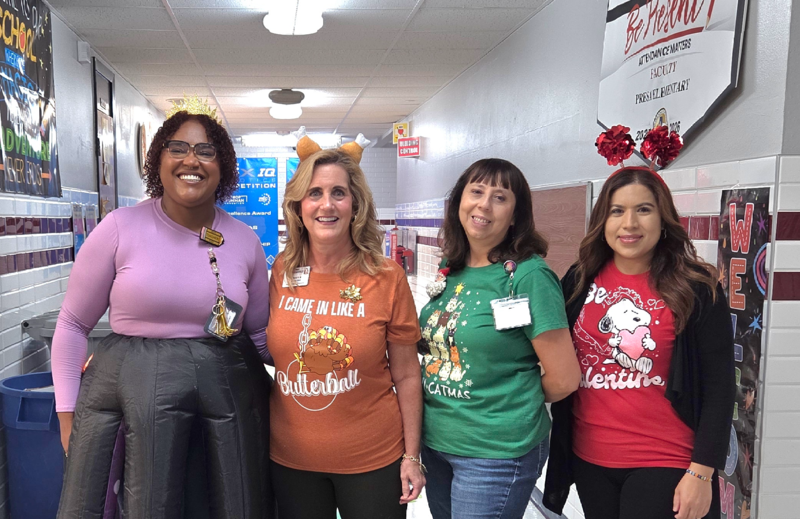 Principal Banegas in Turkey t-shirt with Ms. Jones on her right, Mrs. Lowenburg on her left and Mrs. Arguijo next.