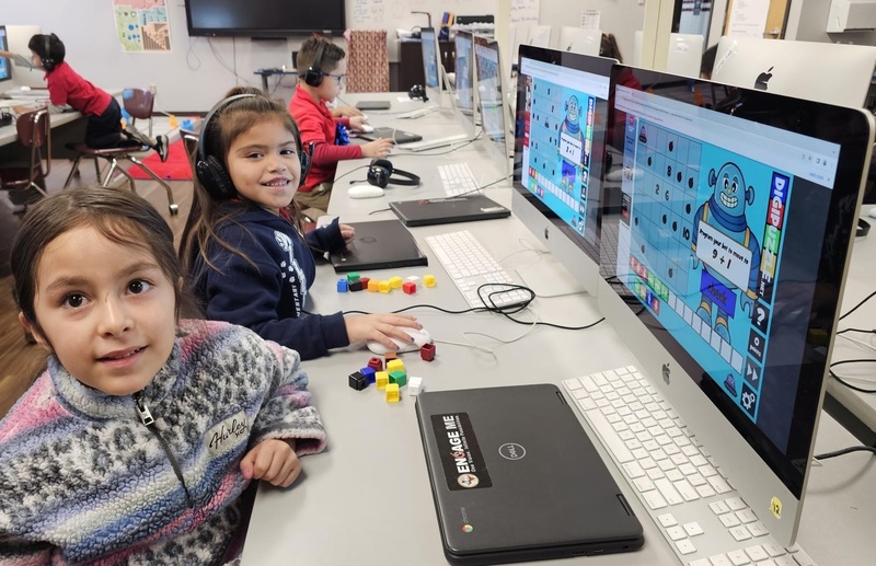 Kinder students practicing math and coding at the same time on desktops