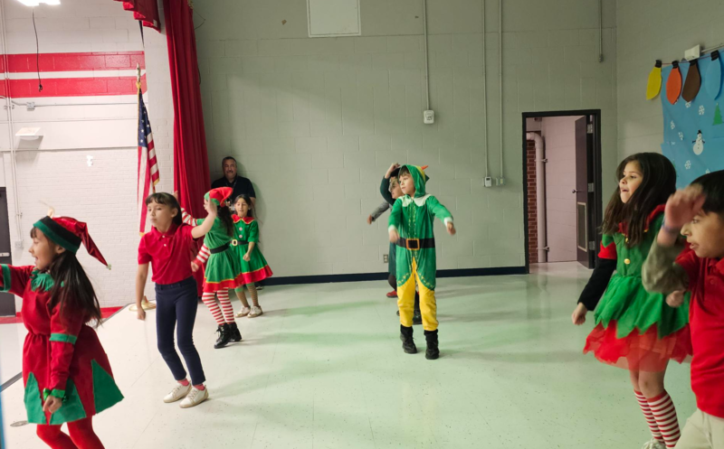 Mrs. Alcocer's class shows off their dance moves on stage dressed as elves