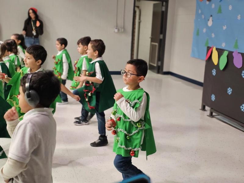 Ms. Calderon and Ms. Hernandez' class dances with their Christmas Tree outfits on stage