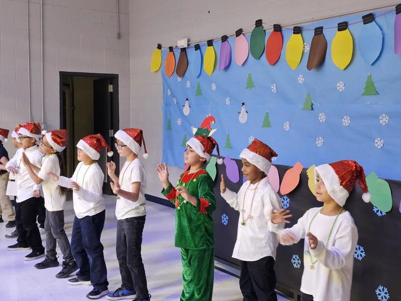 Ms. Casillas' class show off their dance moves on stage in Red Santa Hats