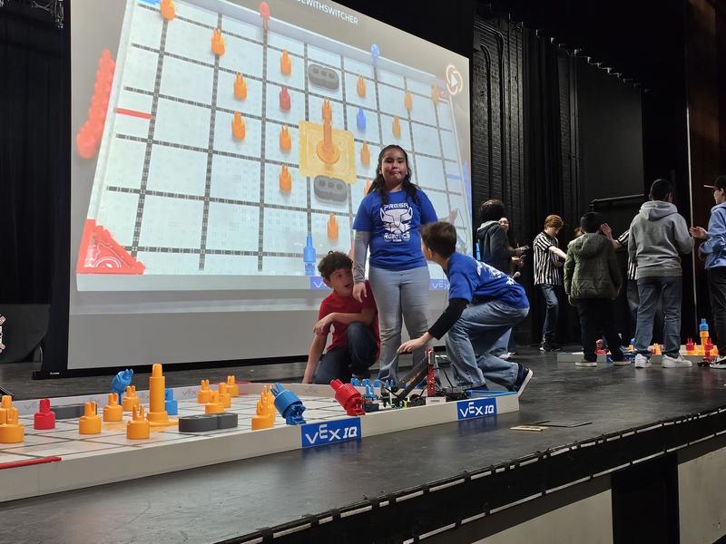 Team C preparing the bot on stage