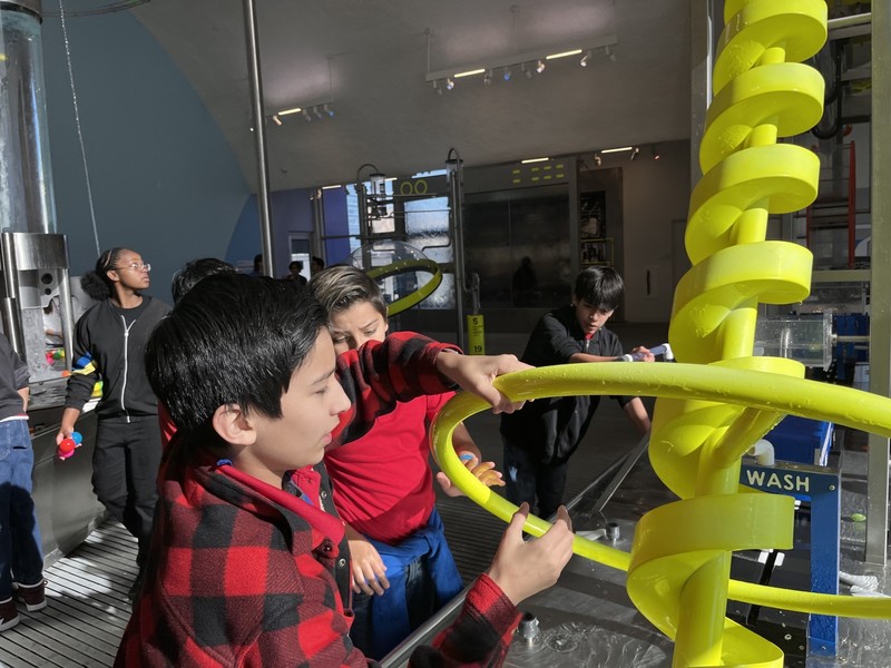 Student playing with Science Exhibit