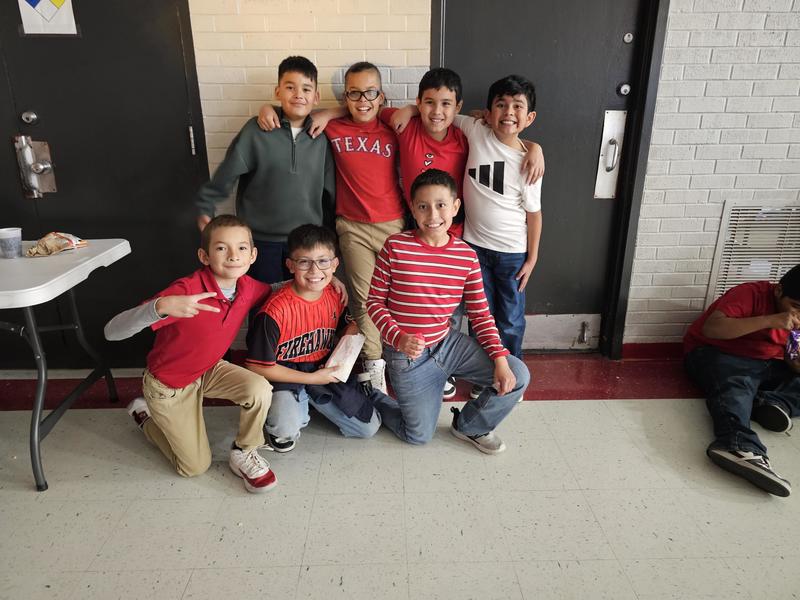 4th grade boys pose against the wall for a picture