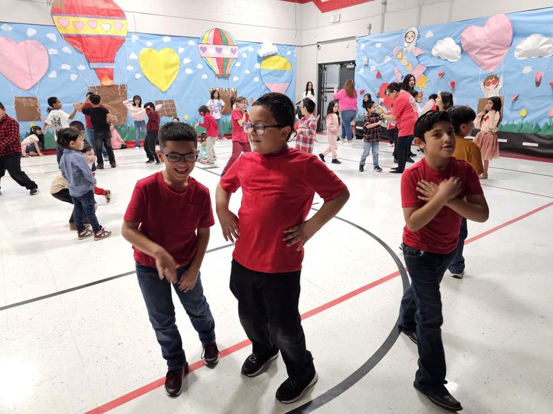 Presa boys in red shirts dancing to the Macarena song
