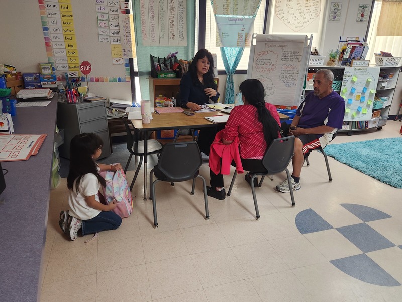 Teacher conferencing with parent and student