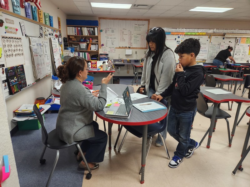 Teacher conferencing with parent and student