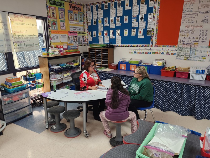 Teacher conferencing with parent and student