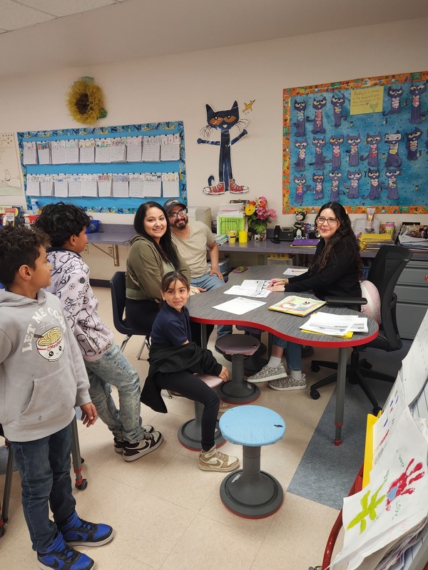 Teacher conferencing with parent and student