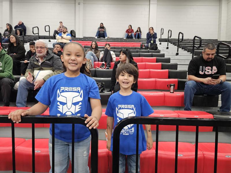 Siblings of Team Z cheering in the stadium