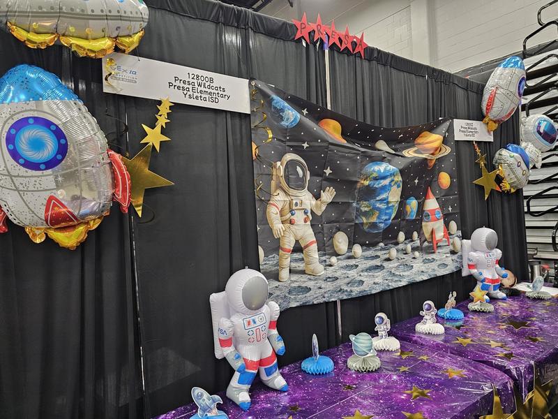 Presa's Tables decorated with an Astronaut theme with backdrop of being on the moon and smaller table top astronauts