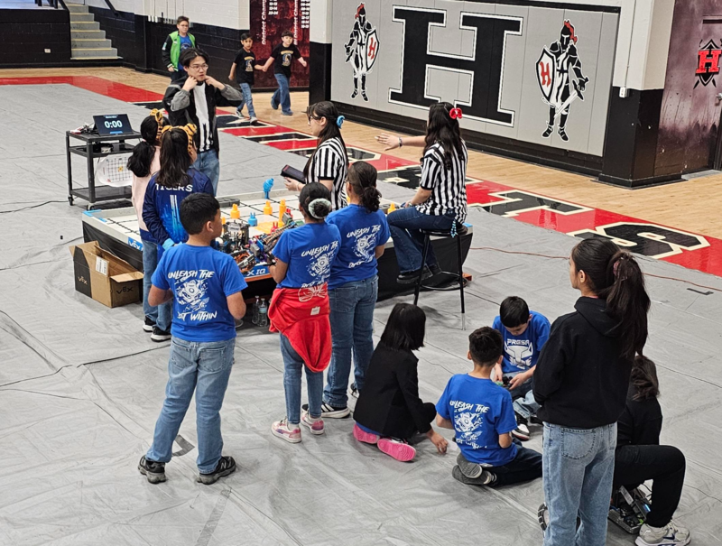 Both teams waiting at the Skills table