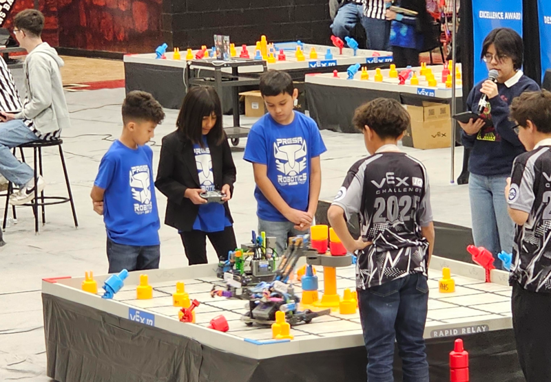 Team Z's female driver moving the robot using the remote control