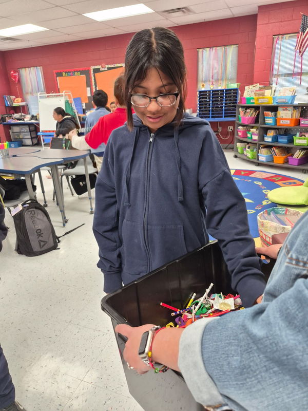 4th grader chooses her prize front of the treasure chest