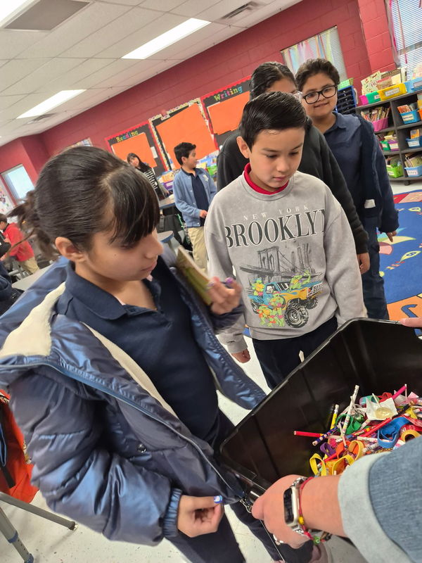 4th graders line up to grab a treasure for being on time