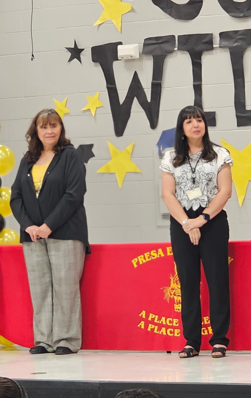 Ms. Jacquez on stage with other teachers at awards assembly