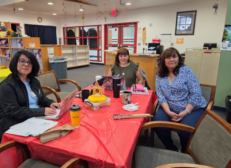 AP Jacquez in a staff meeting at a table 