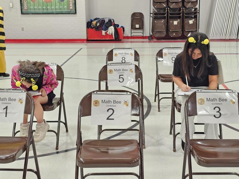 4th grade contestants working on the paper test to determine the winner