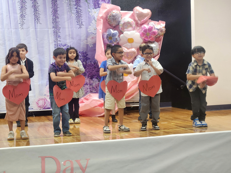 Ms. Olsen's kids dancing for mom on stage