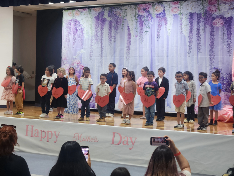 Ms. Olsen's kids dancing for mom on stage