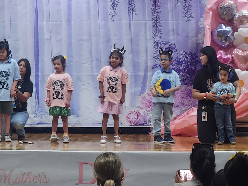 Ms. Esparza's kids on stage singing for mom
