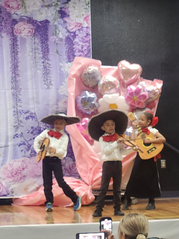 Ms. Guerreros's kids playing mariachi instruments