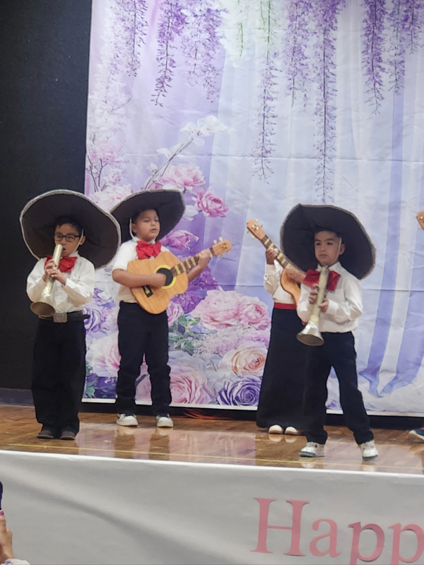 Ms. Guerreros's kids playing mariachi instruments